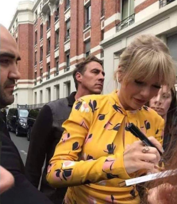 Taylor Swift signing autographs in yellow dress Boston memorabilia