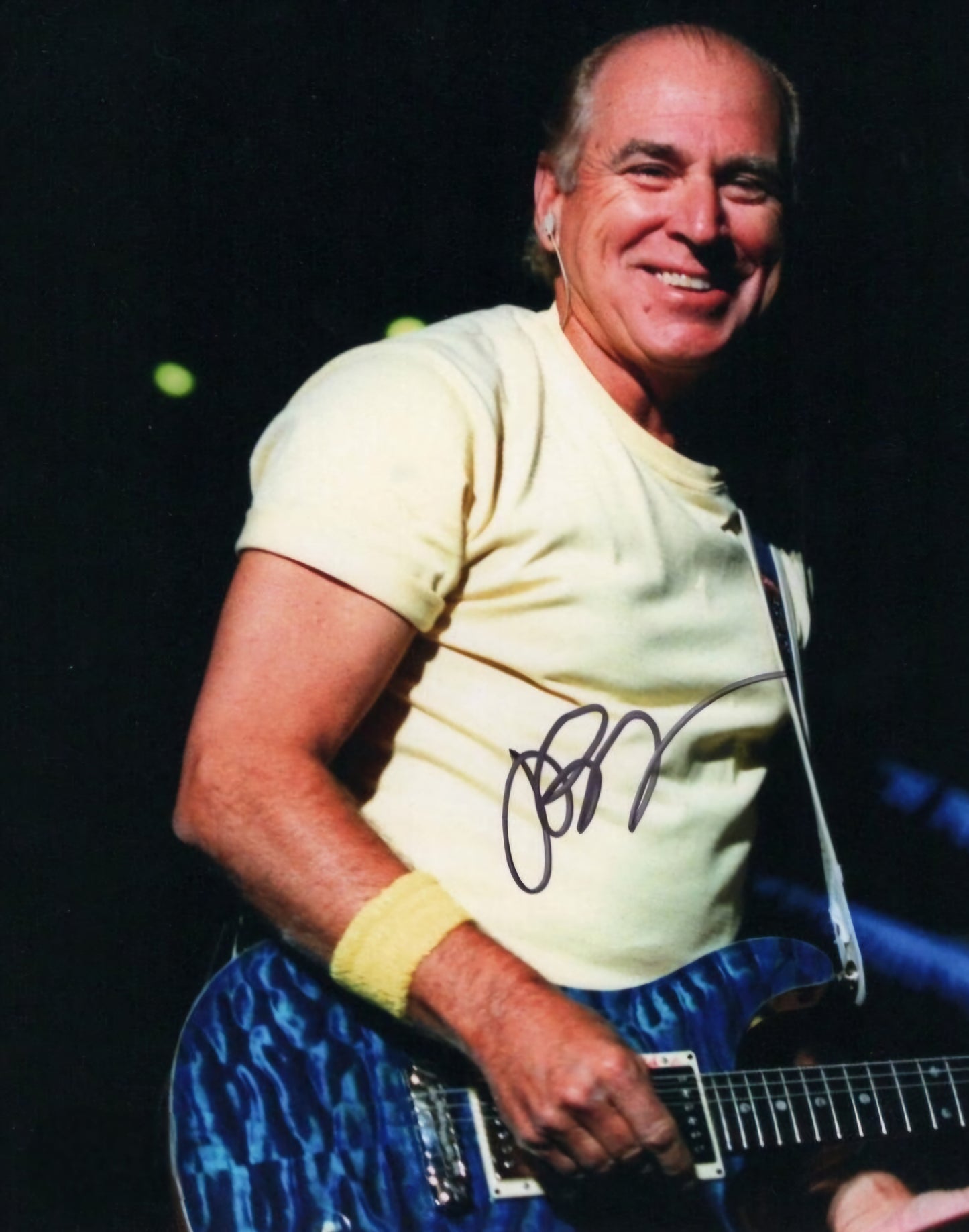 Jimmy Buffett signed photo black marker strumming guitar