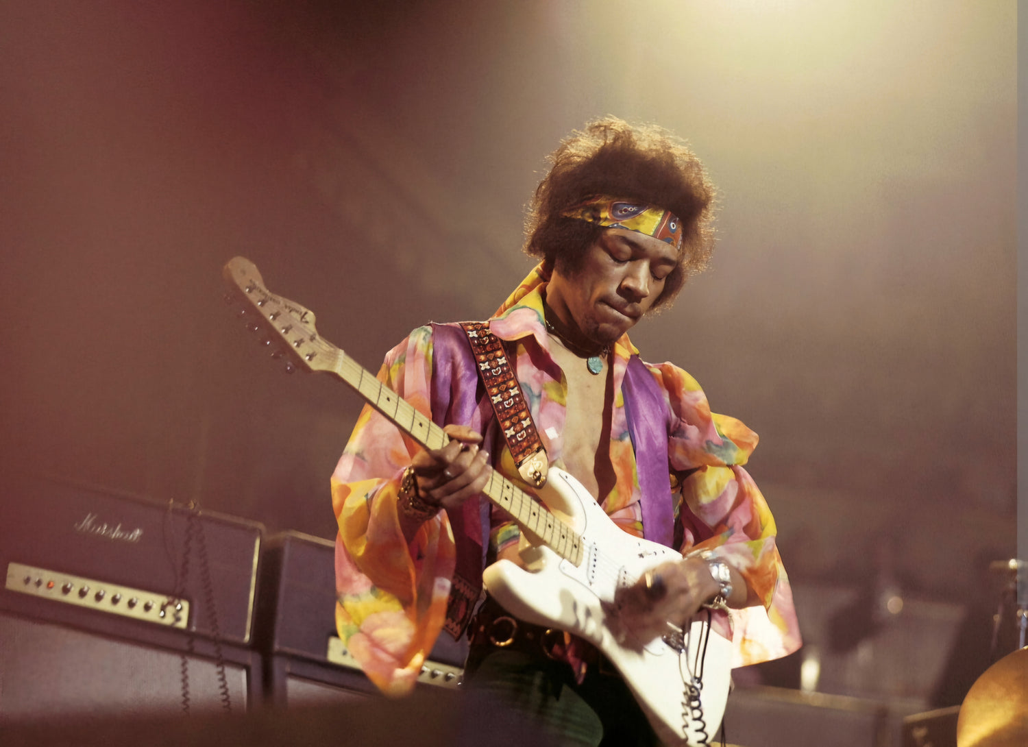 Jimi Hendrix on stage playing guitar Beckett autographs