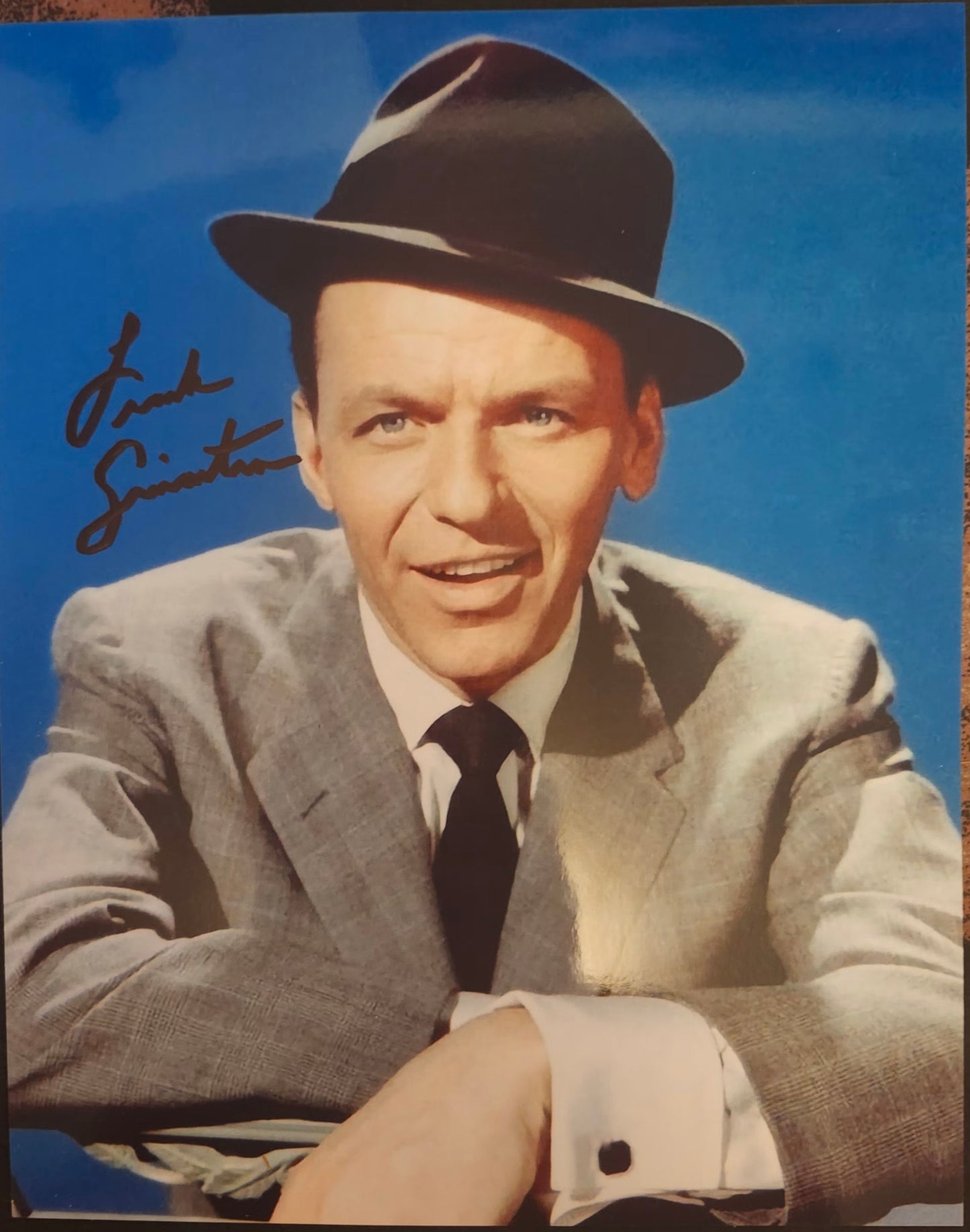 Frank Sinatra signed photo blue background black hat