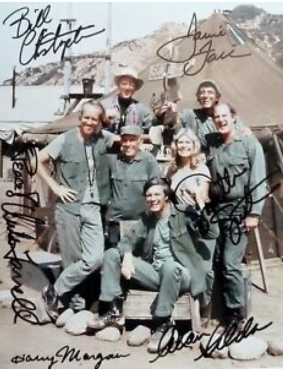 Mash cast sign photo in front of the tent