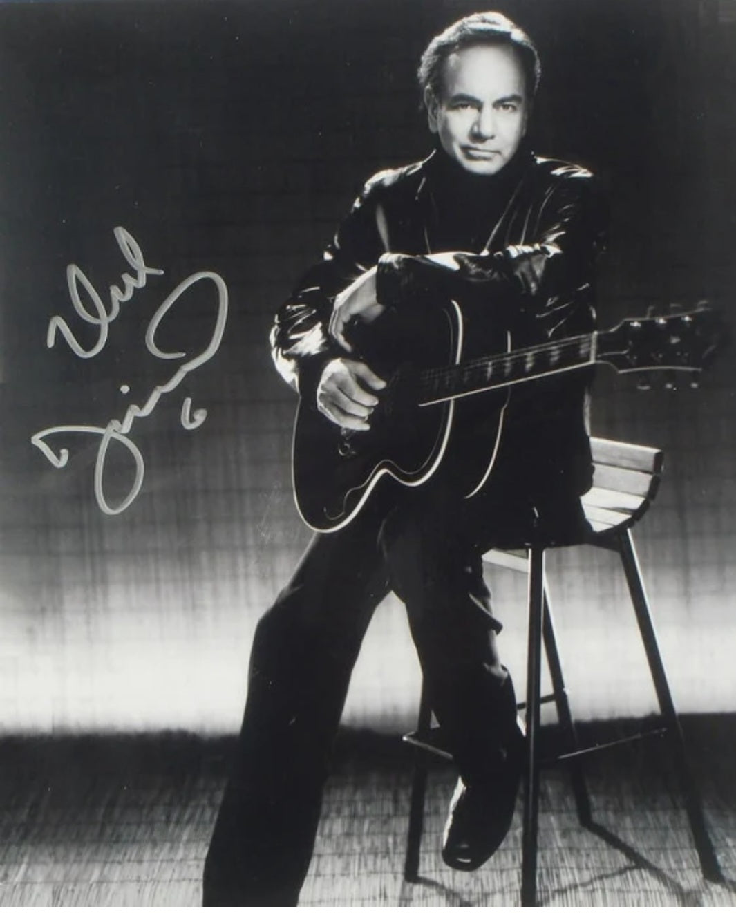 Neil Diamond signed photo sitting with guitar