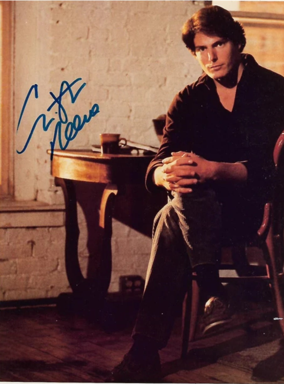 Christopher Reeve signed photo blue marker sitting at table