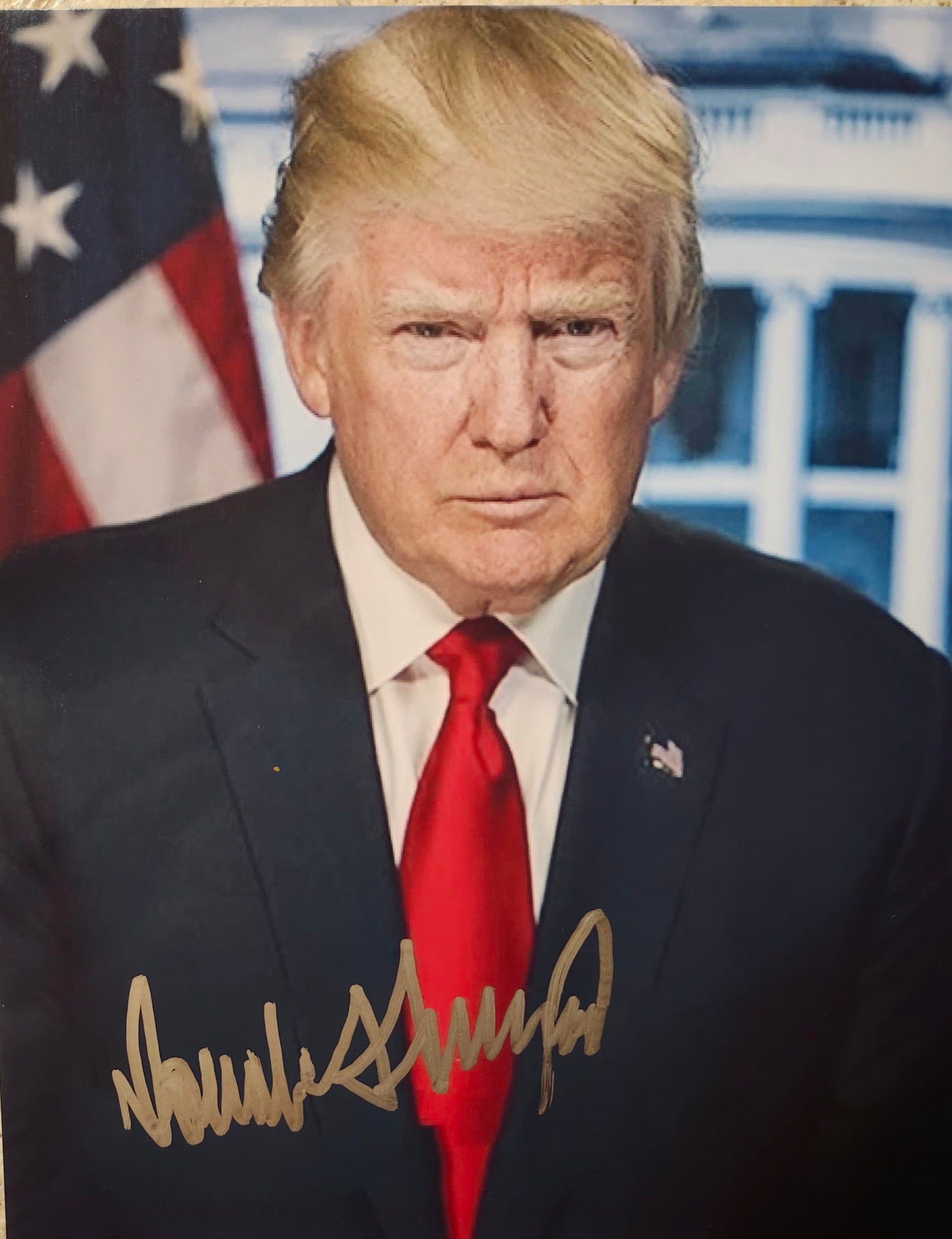 donald trump signed photo in silver marker white house in background