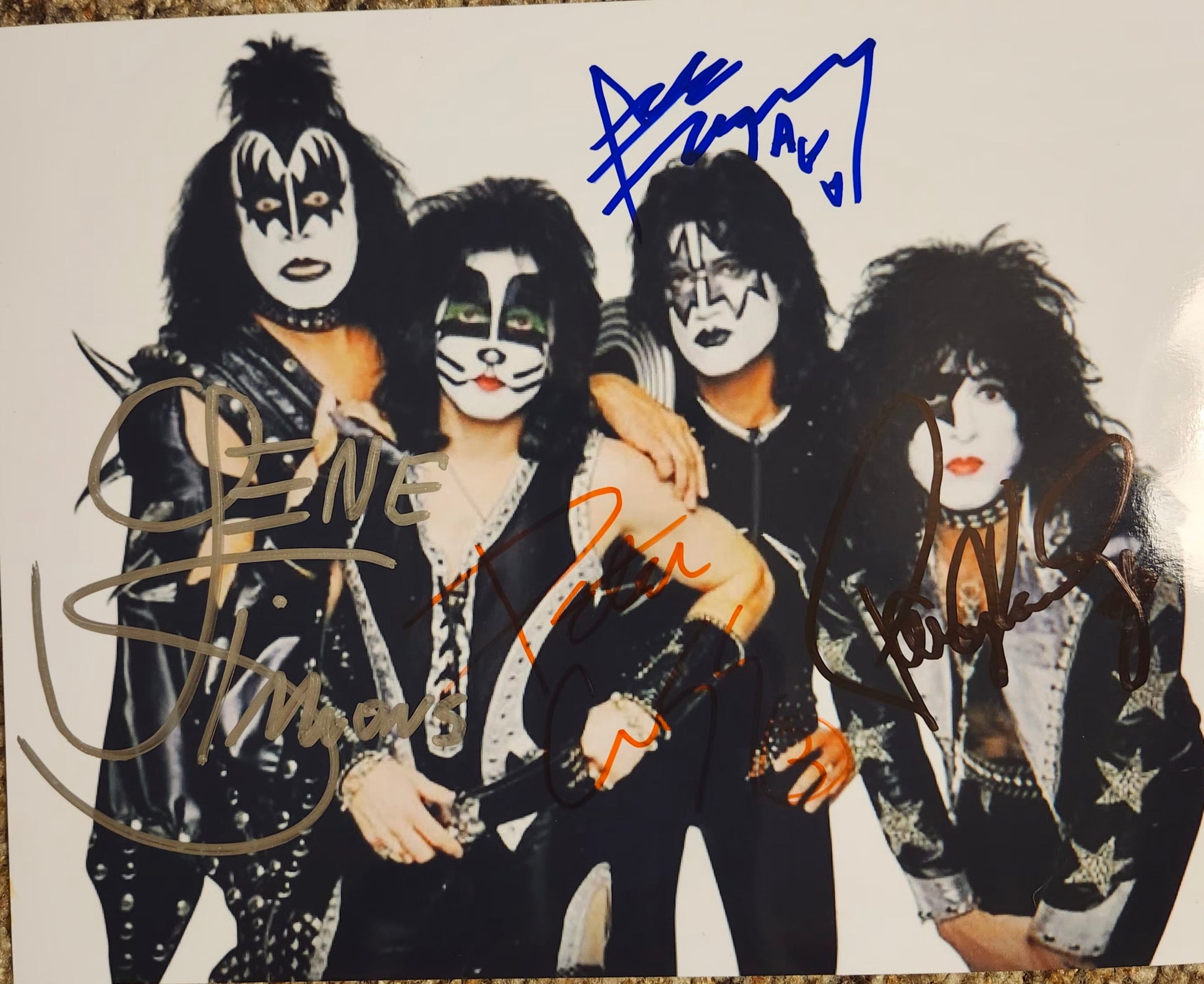 kiss band signed photo white background